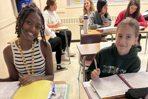  two students sitting at a desk together